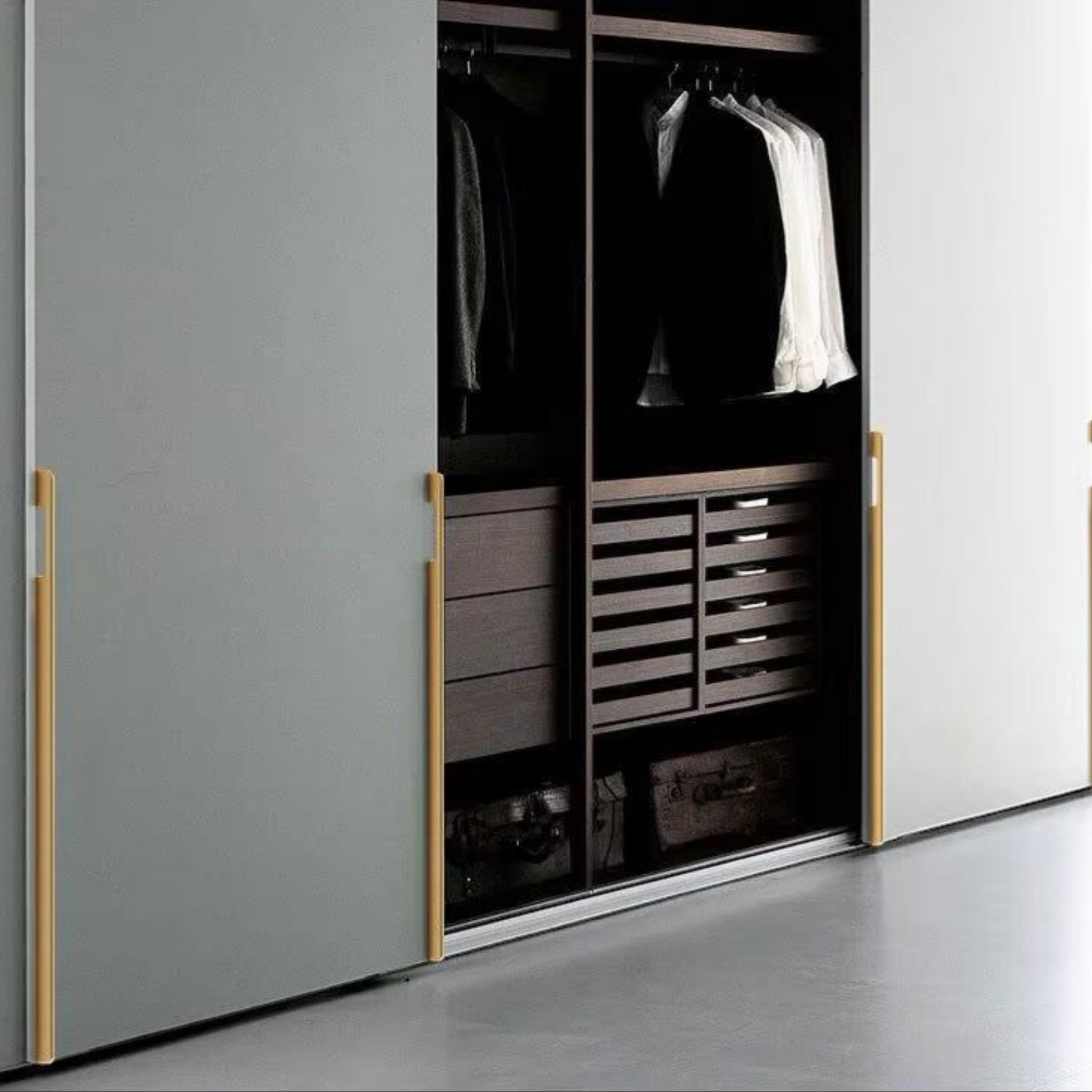Extra-long modern aluminum cabinet handle in matte black and gold finish on wardrobe door