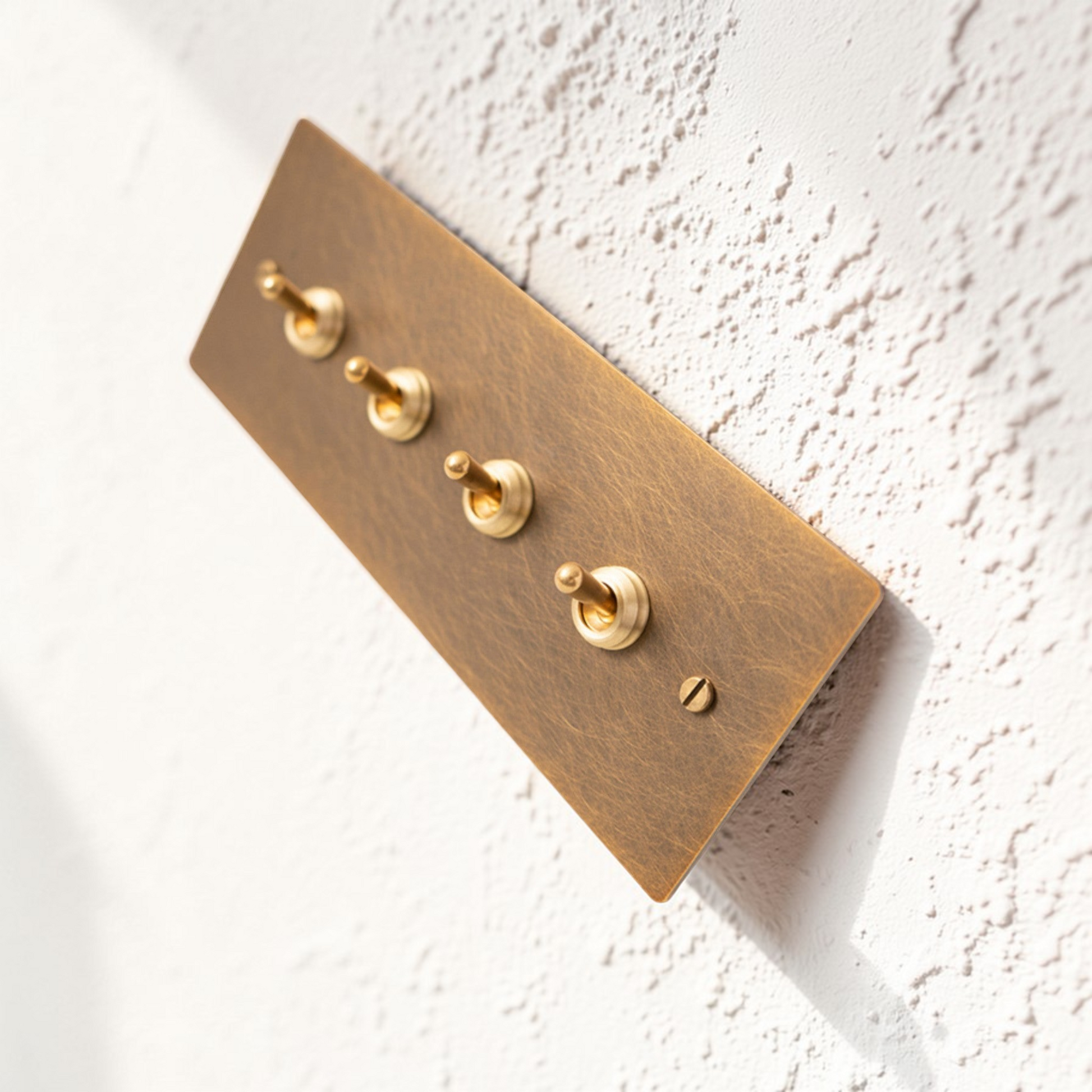 Retro aged brass toggle and dimmer switch panel in 1–4 gang options made from solid brass.