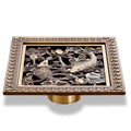 Collection of 12 antique brass carved square shower drains with ornate designs including floral medallion, geometric mandala, sailing boat, and nature motifs