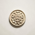 A luxury wardrobe door featuring a central oval floral wood applique painted in a vintage wash.