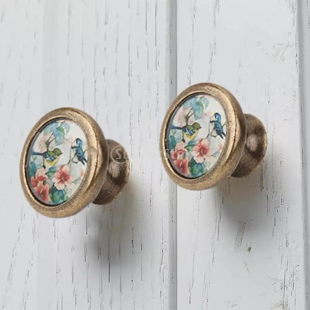Vintage brass cabinet knob with birds and floral decorative design