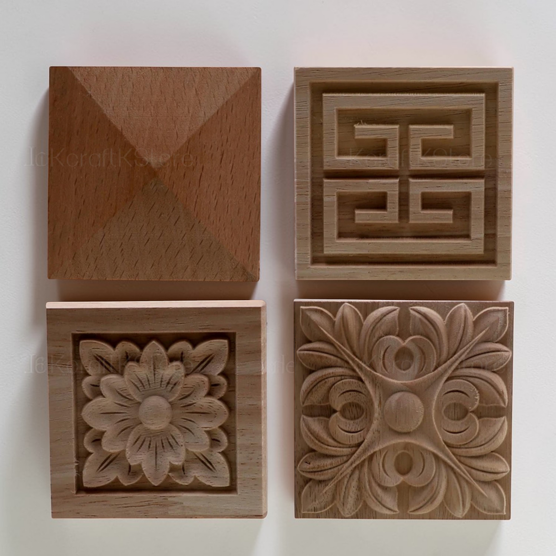 Close-up of a wooden cabinet door decorated with painted square floral onlays.