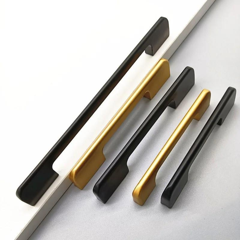 Extra-long modern aluminum cabinet handle in matte black and gold finish on wardrobe door