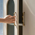 Close-up of antique brass drawer pull with knurled detailing