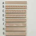 Set of decorative cornice molding samples on a light gray background