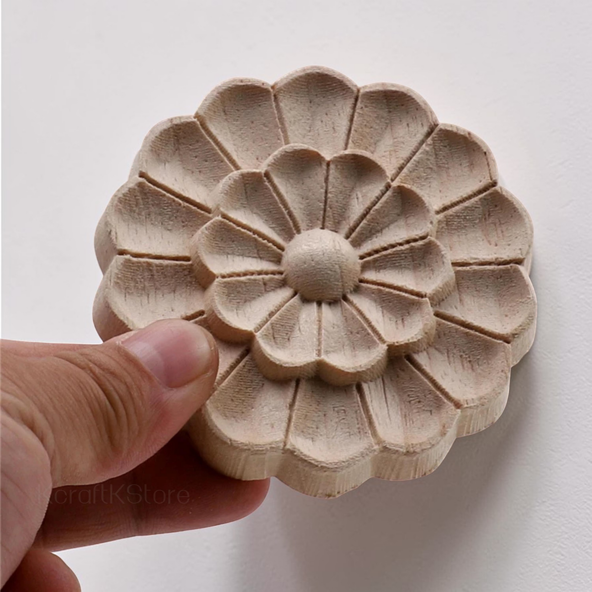 A luxury cabinet door featuring a central round floral wood onlay painted in gold.